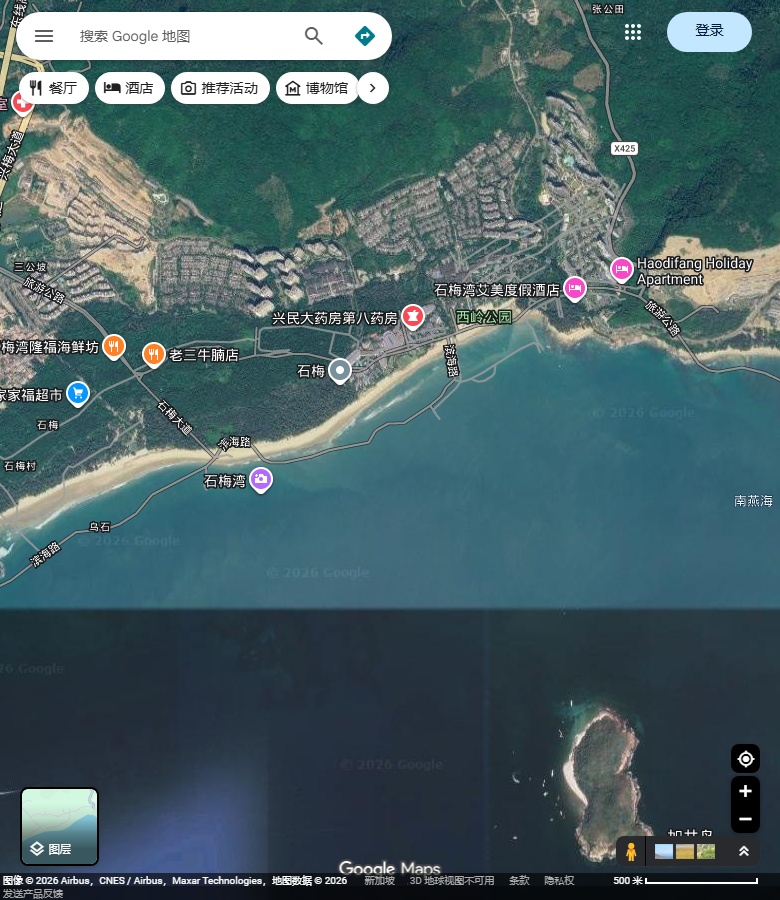 石梅湾弧形长沙岸、林地山坡、湾东岸体与部分加井岛。 Google Maps卫星图；2026-09-10查看，北向上。